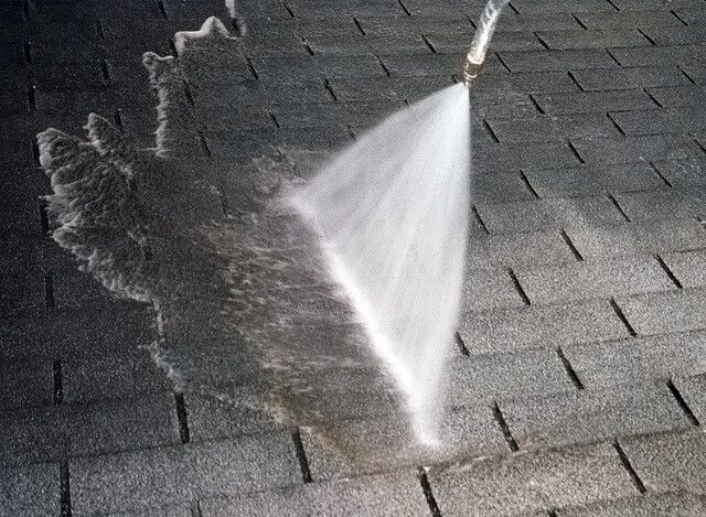 Roof being power washed as part of Greer services. 