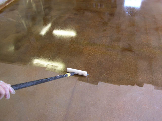 Floor being coated by Greer painting. 