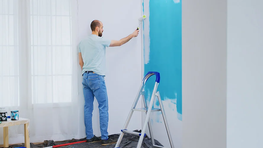 Professional Painter Painting Interior Wall Blue