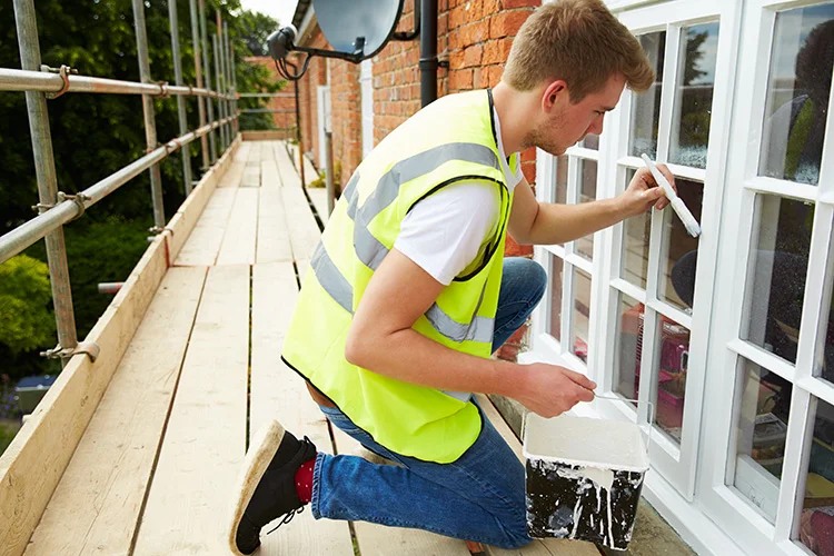 Exterior Paint Prep - Painter on Scaffolding Painting Windows